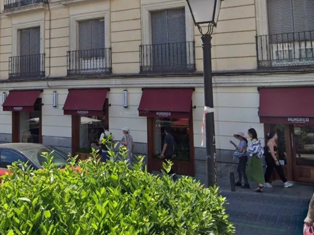 Toldos granates de HUNDRED, en la plaza de Pedro Zerolo